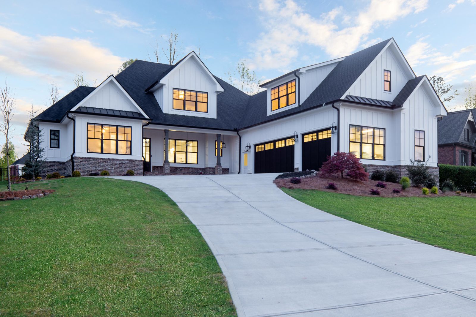 Front elevation with the driveway curving to the garage doors — Glausier, custom home built by Ironwood Construction Group