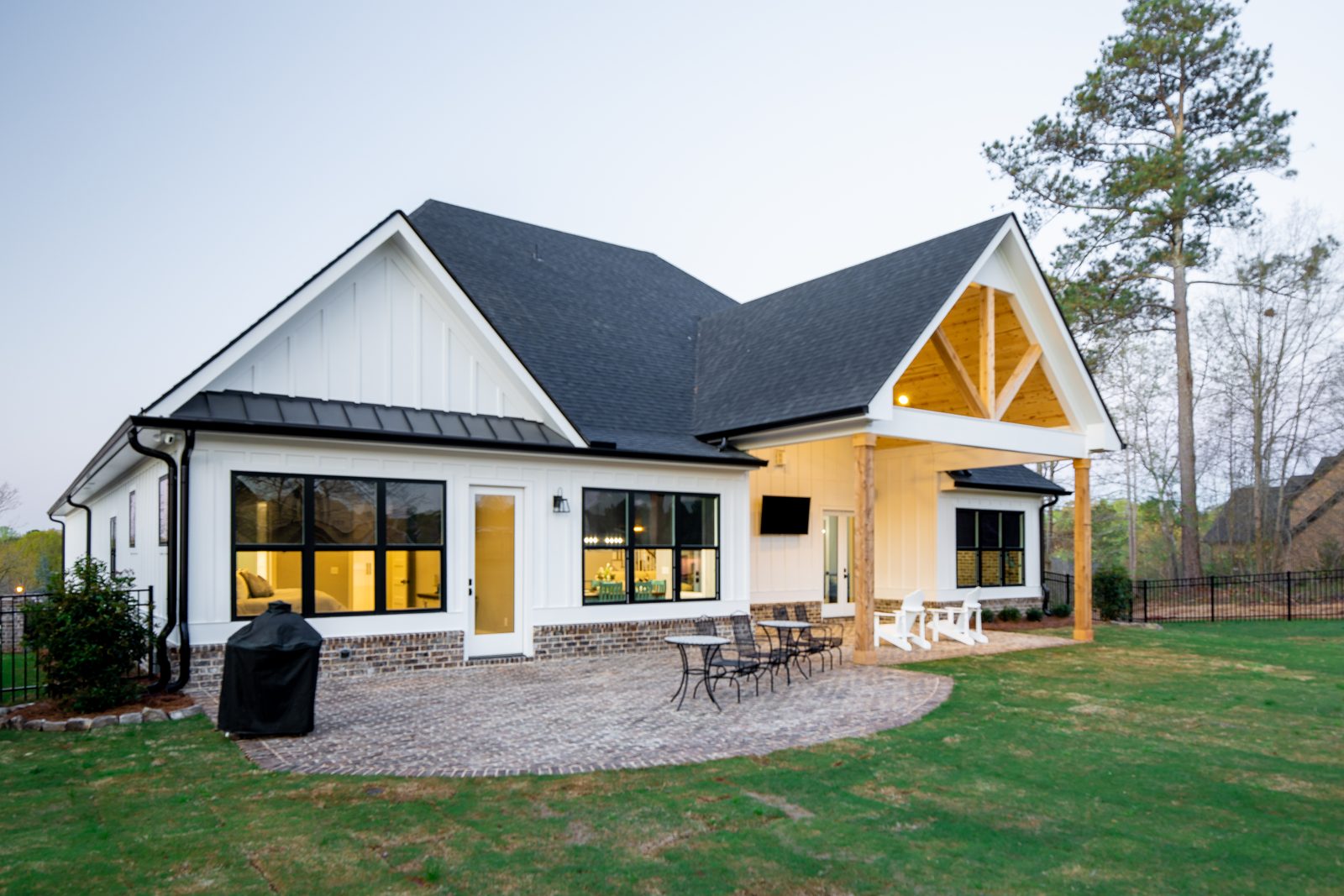 Rear elevation with covered porch, timber gable and paver patio — Spring 2020 Custom Home, custom home built by Ironwood Construction Group